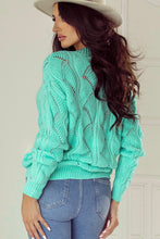 Model wearing a Black Hollow Out Knit V Neck Drop Shoulder Sweater in mint green with jeans and a hat.