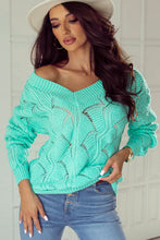 Model wearing a Black Hollow Out Knit V Neck Drop Shoulder Sweater in mint green with stylish jeans and a hat.